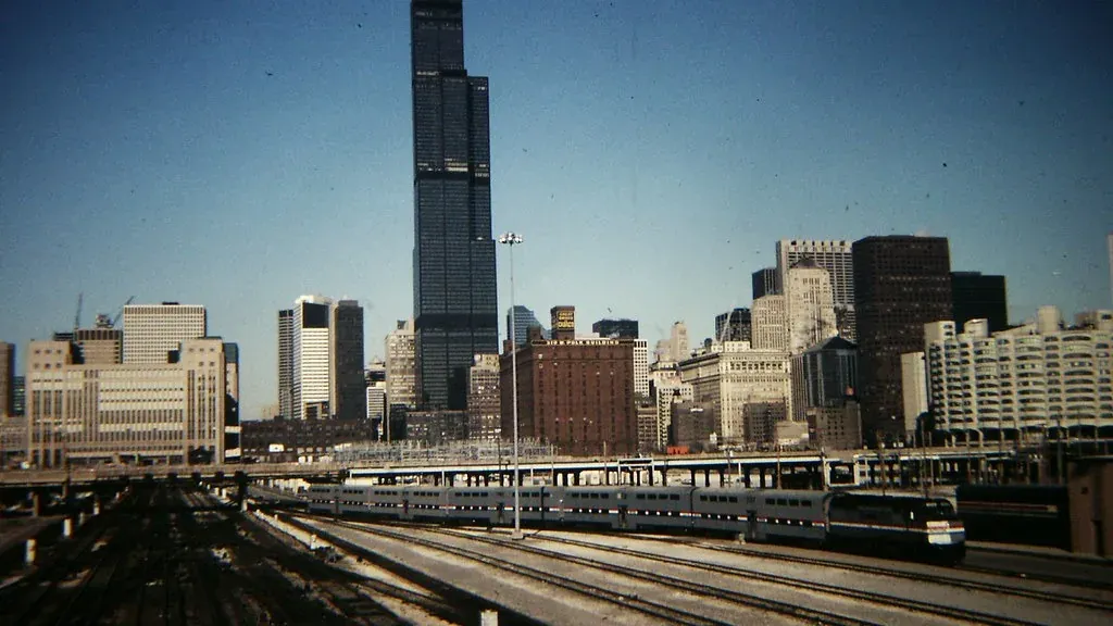 Rail lines running toward the Chicago skyline with Willis Tower above the downtown blocks
