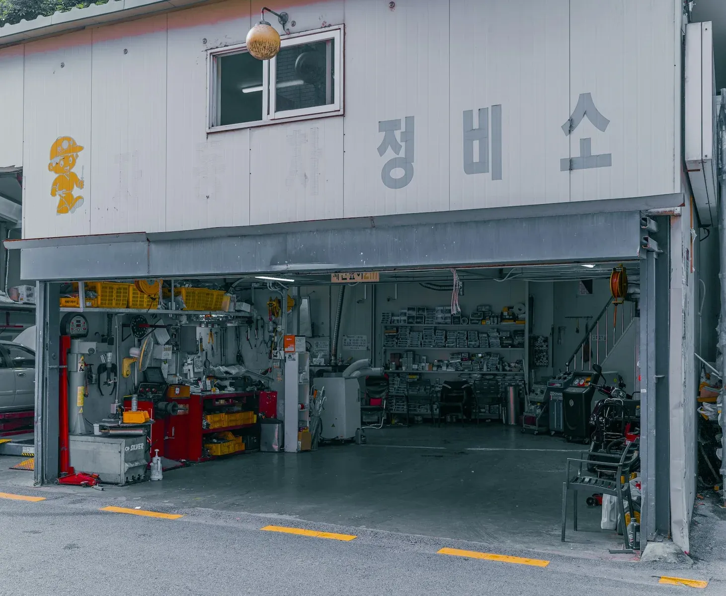 Open auto repair garage with tools and service bays