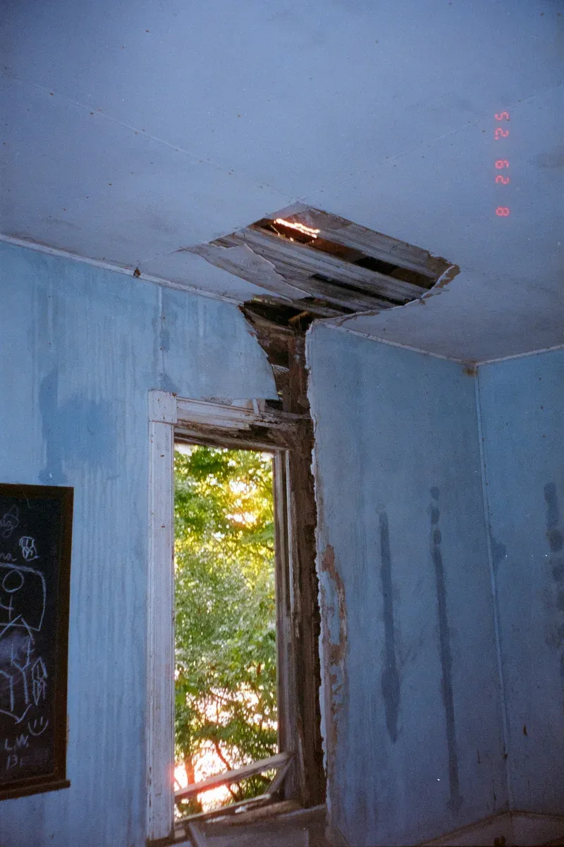 Interior room with ceiling and window damage